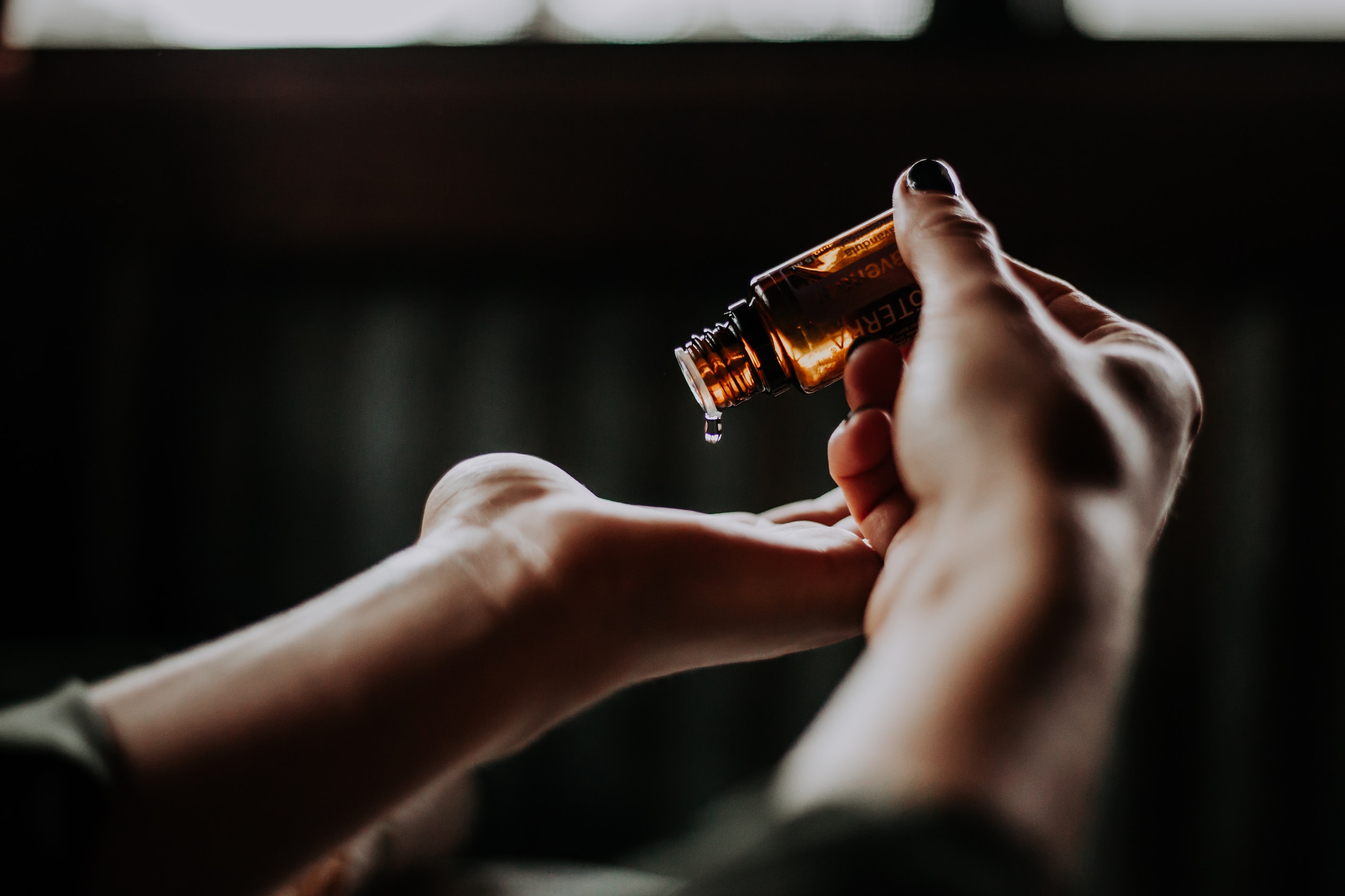 hands pouring oil